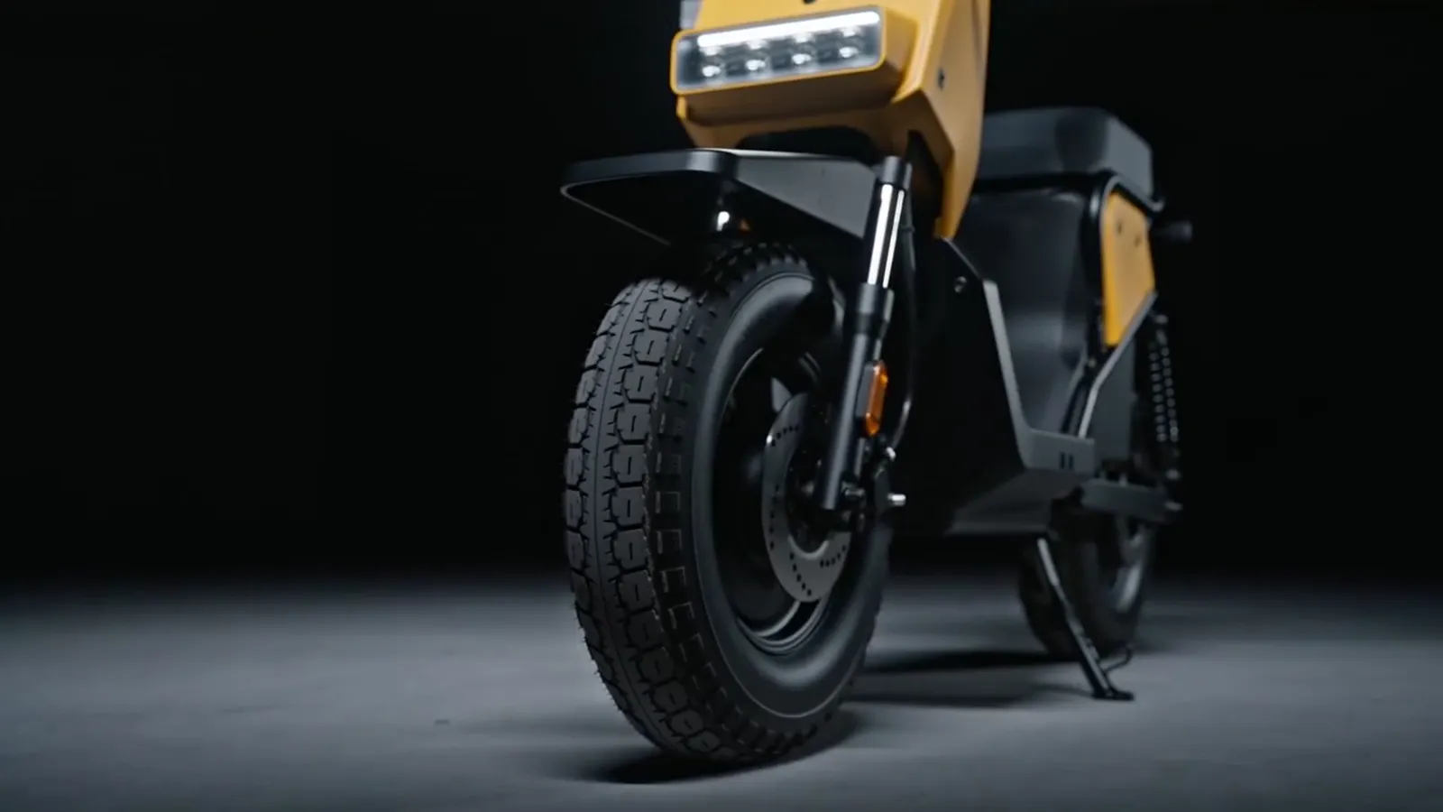 Studio pass on a two-wheeler: chrome, rubber, and hard rim light.